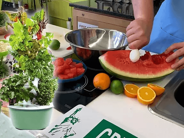 Fresh vegetables and a classroom harvest prepared on a cutting board