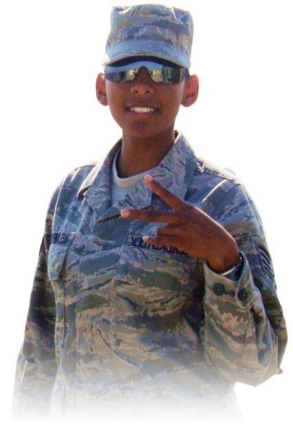 Person in camouflage military uniform and cap making a peace sign gesture with sunglasses.