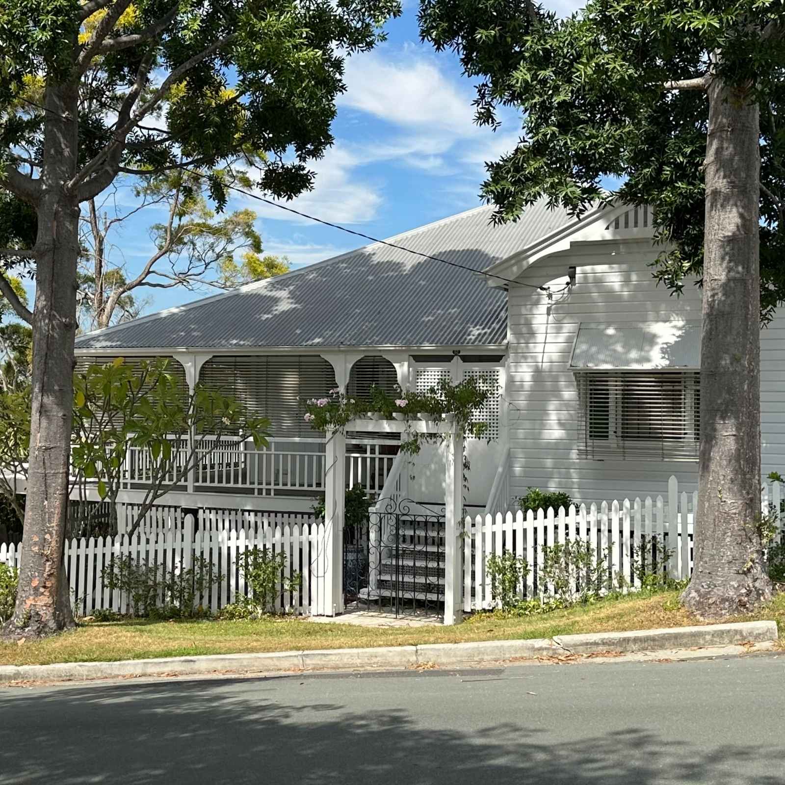 White Queenslander rental home in inner Brisbane representing trusted local property management