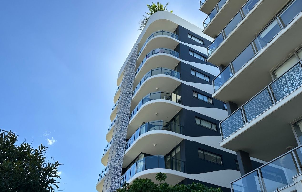 Modern Brisbane apartment building representing rental property maintenance coordination