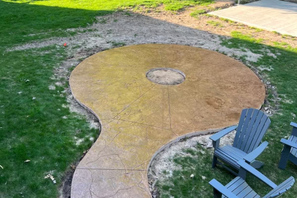 Custom concrete firepit pad in West Michigan backyard