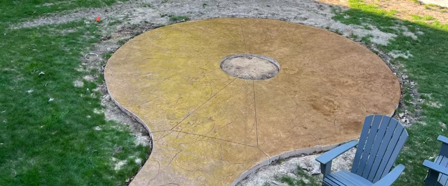 Custom concrete firepit pad in West Michigan backyard