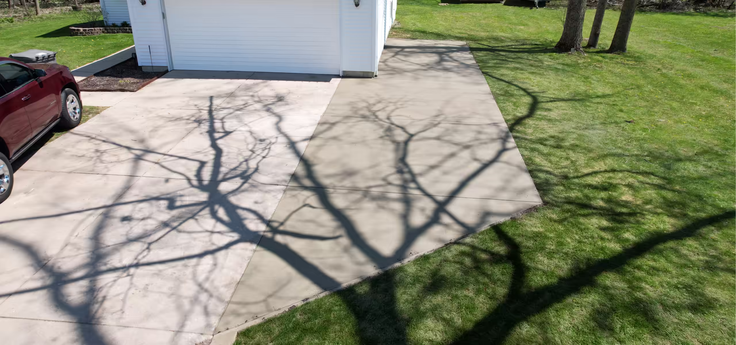 Broom finish concrete driveway extension poured by Pro Concrete Services in Grand Rapids, MI
