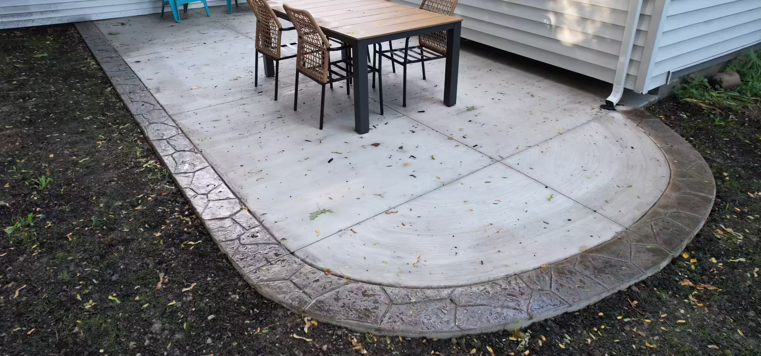 Broom finish patio with stamped border poured by Pro Concrete Services in Grand Rapids, MI