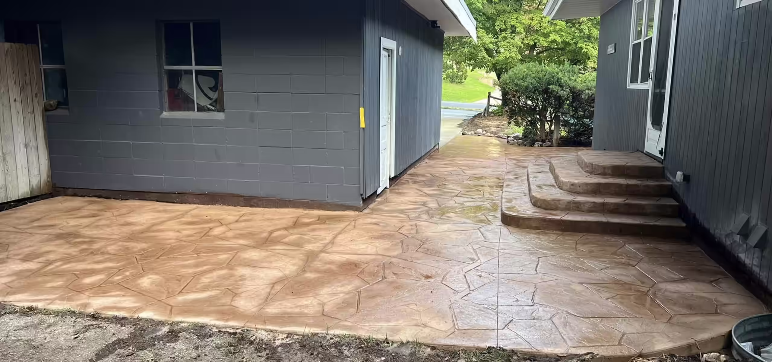 Stamped concrete walkway with flagstone pattern and brown finish installed by Pro Concrete Services in Grand Rapids, MI