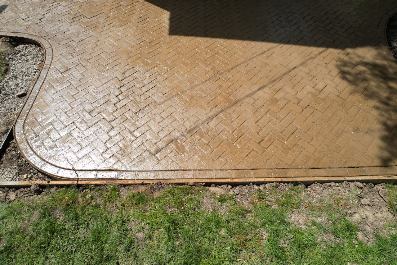 Close-up of herringbone stamped concrete pattern and curved border detail, Grand Rapids MI