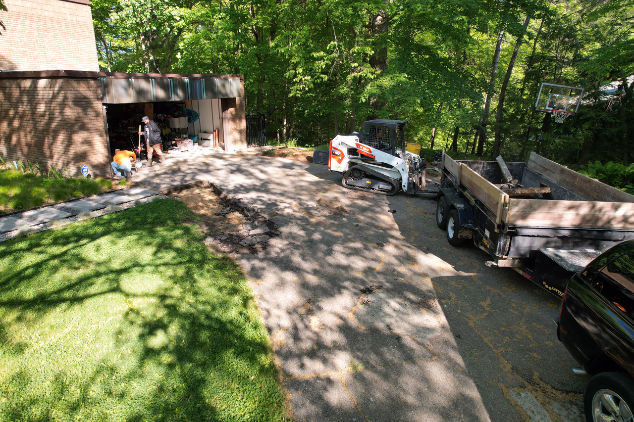Pro Concrete Services crew breaking up and excavating existing driveway, Grand Rapids MI