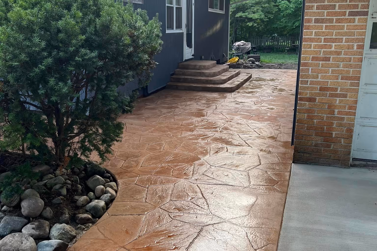 Finished stamped flagstone concrete walkway with decorative steps leading to front entry in Grand Rapids MI