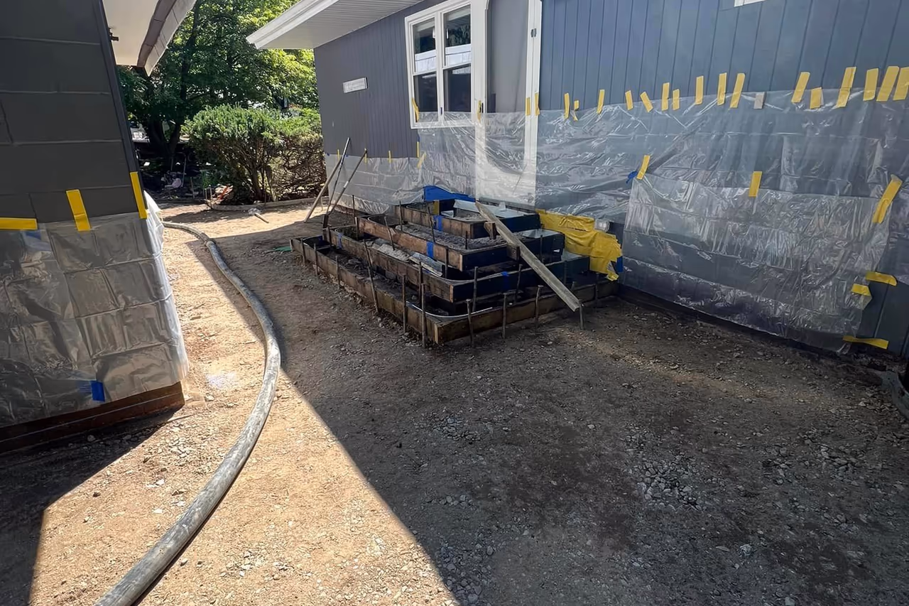 Step forms and steel reinforcement framed and ready for concrete pour during stamped walkway installation in Grand Rapids MI