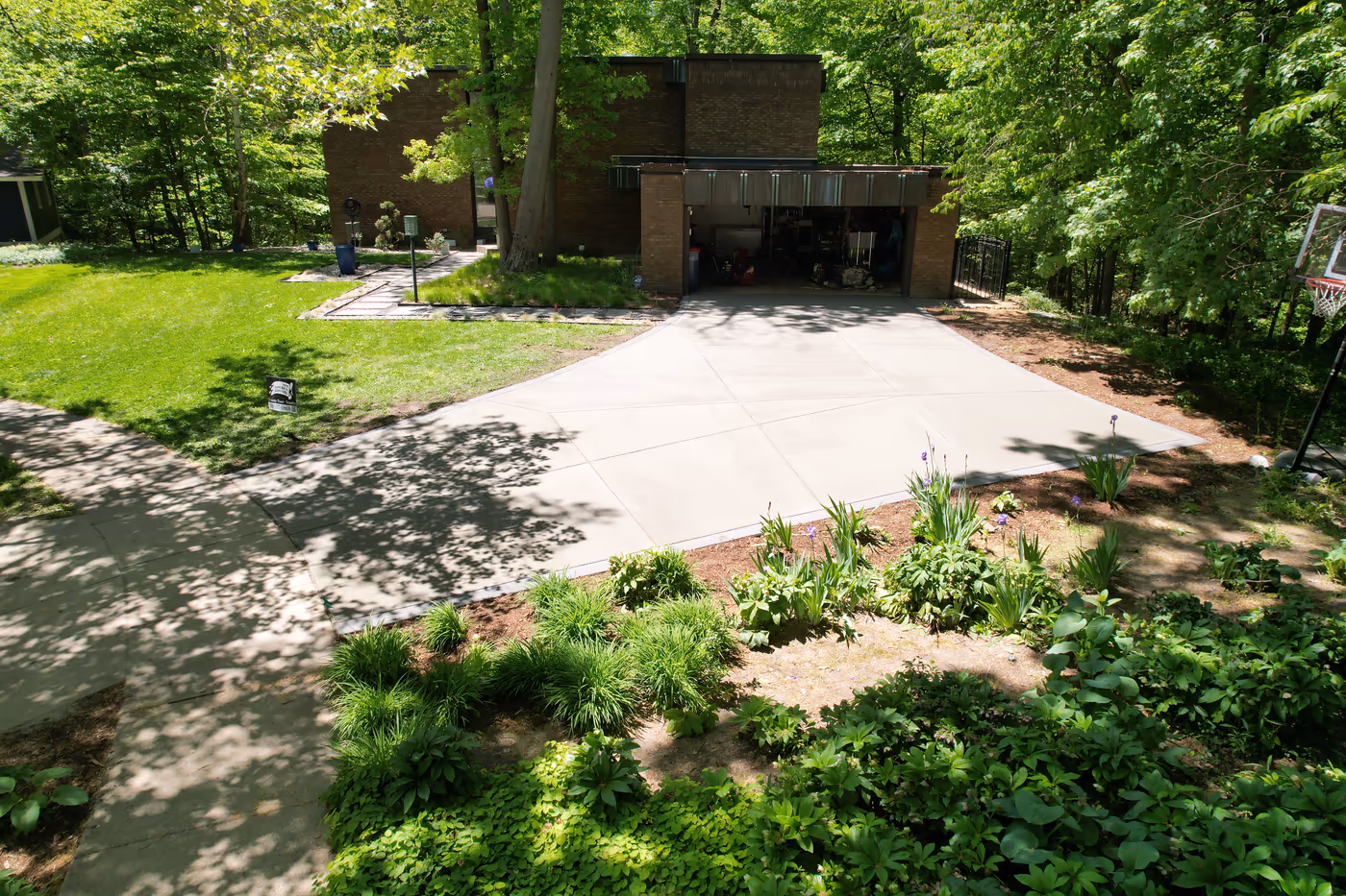 Newly poured modern concrete driveway with scored expansion joints, residential home Grand Rapids MI