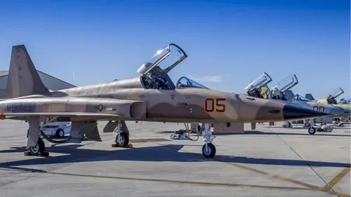 F5 on tarmac in formation in front of aircraft