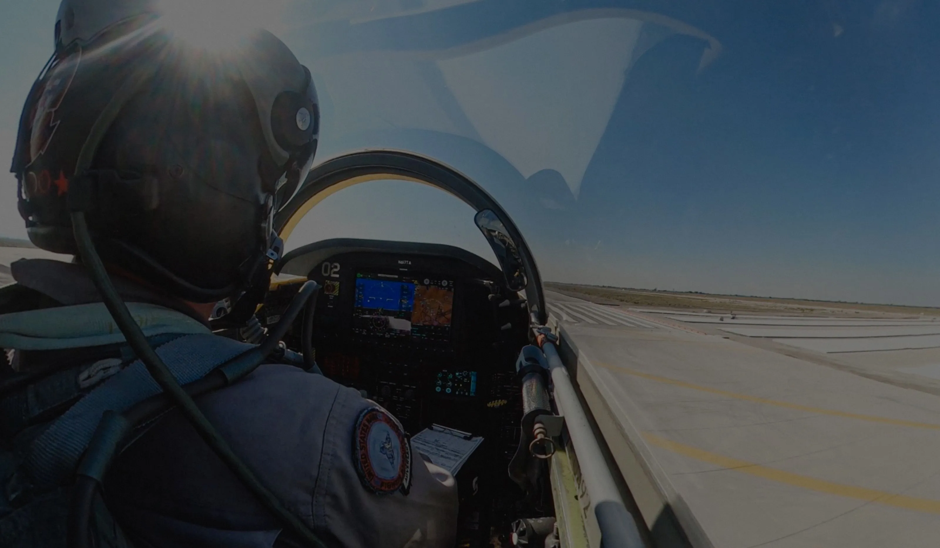 a pilot in a cockpit of a jet
