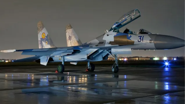 a military jet on a runway