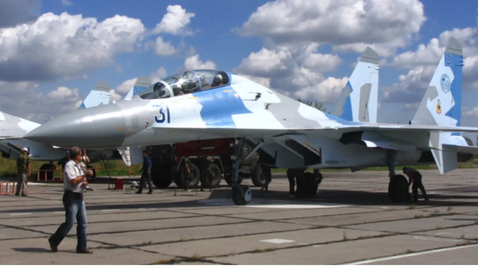 SU-35 aircraft with person walking by