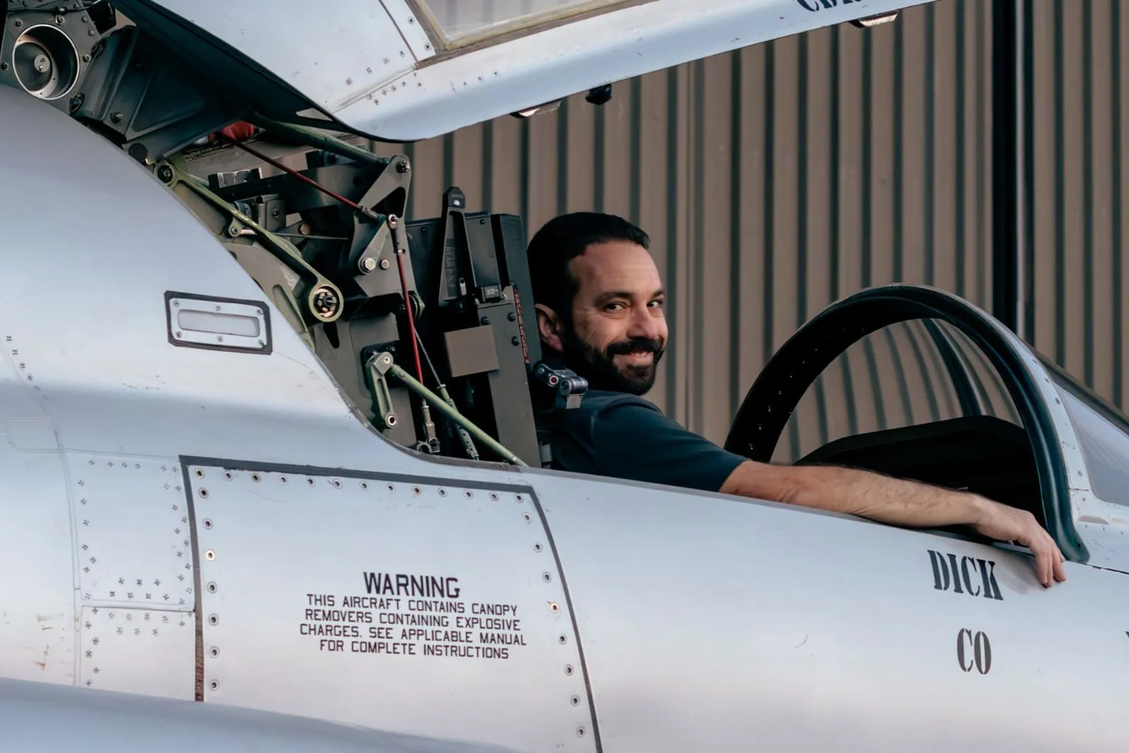 Smiling pilot in F5 cockpit looking at camera