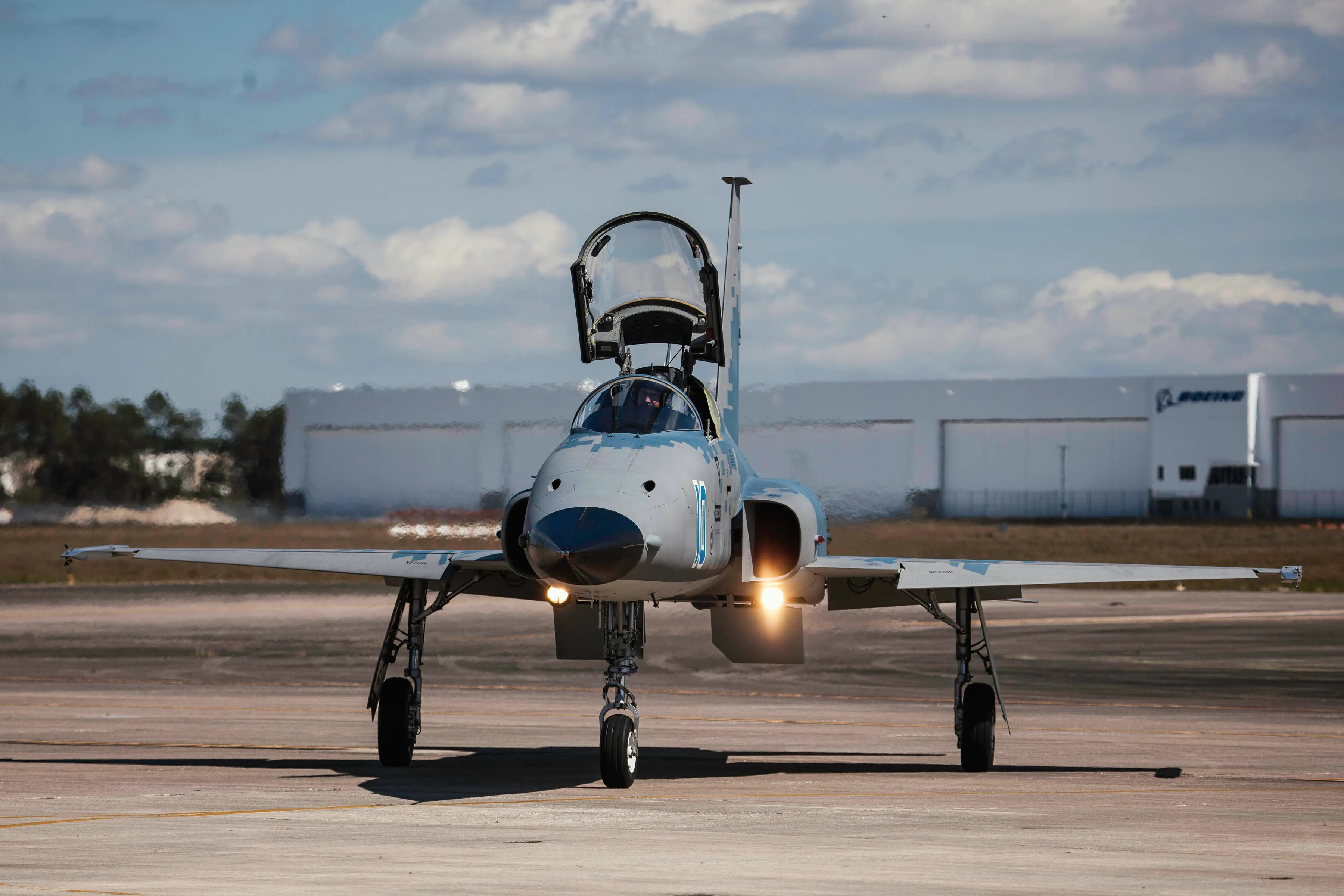 F5 on runway or tarmac with cockpit open