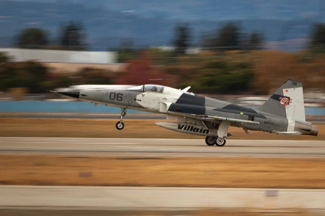 F5 aircraft with landing gear down on runway