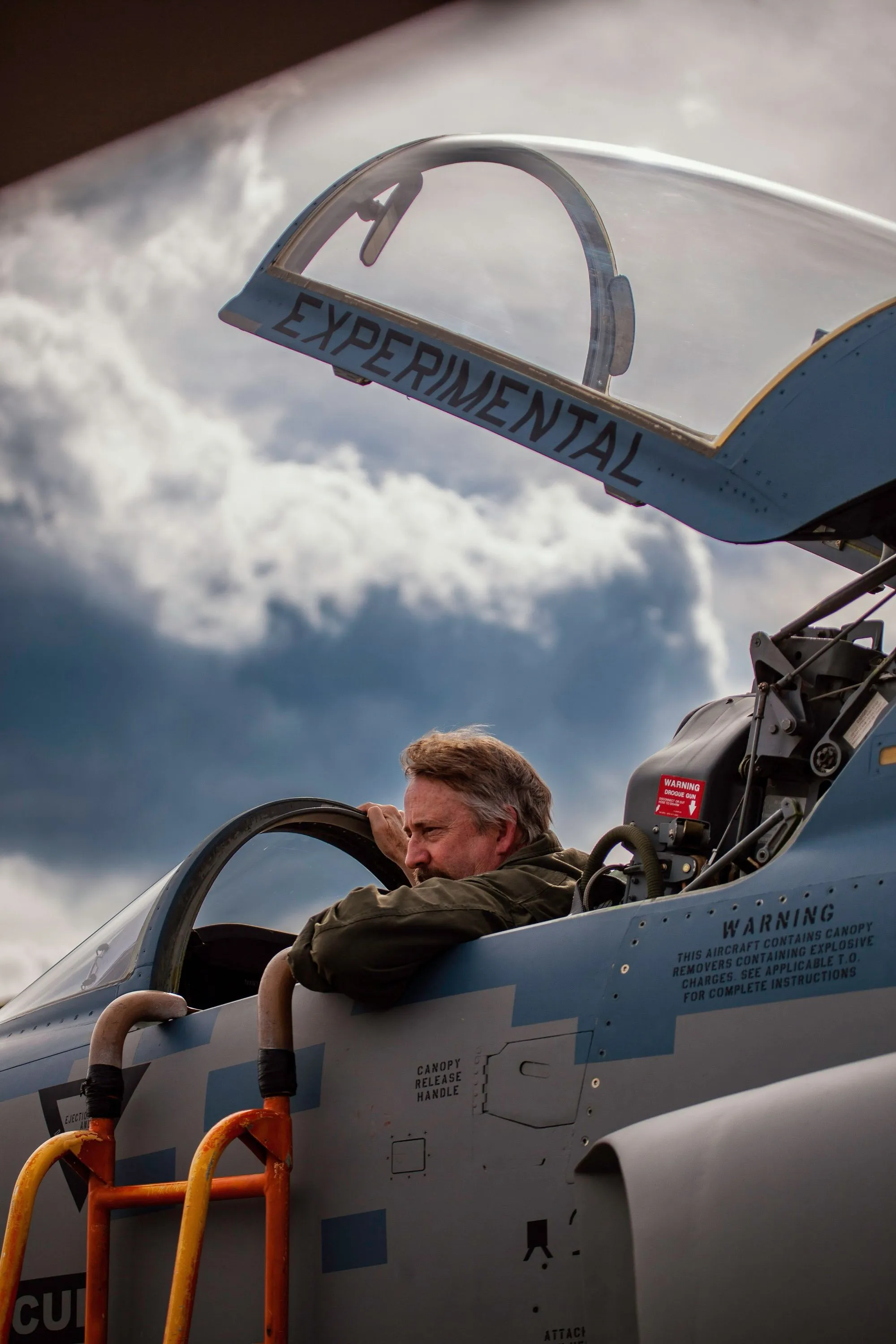 F5 pilot in front of clouds with cockpit open