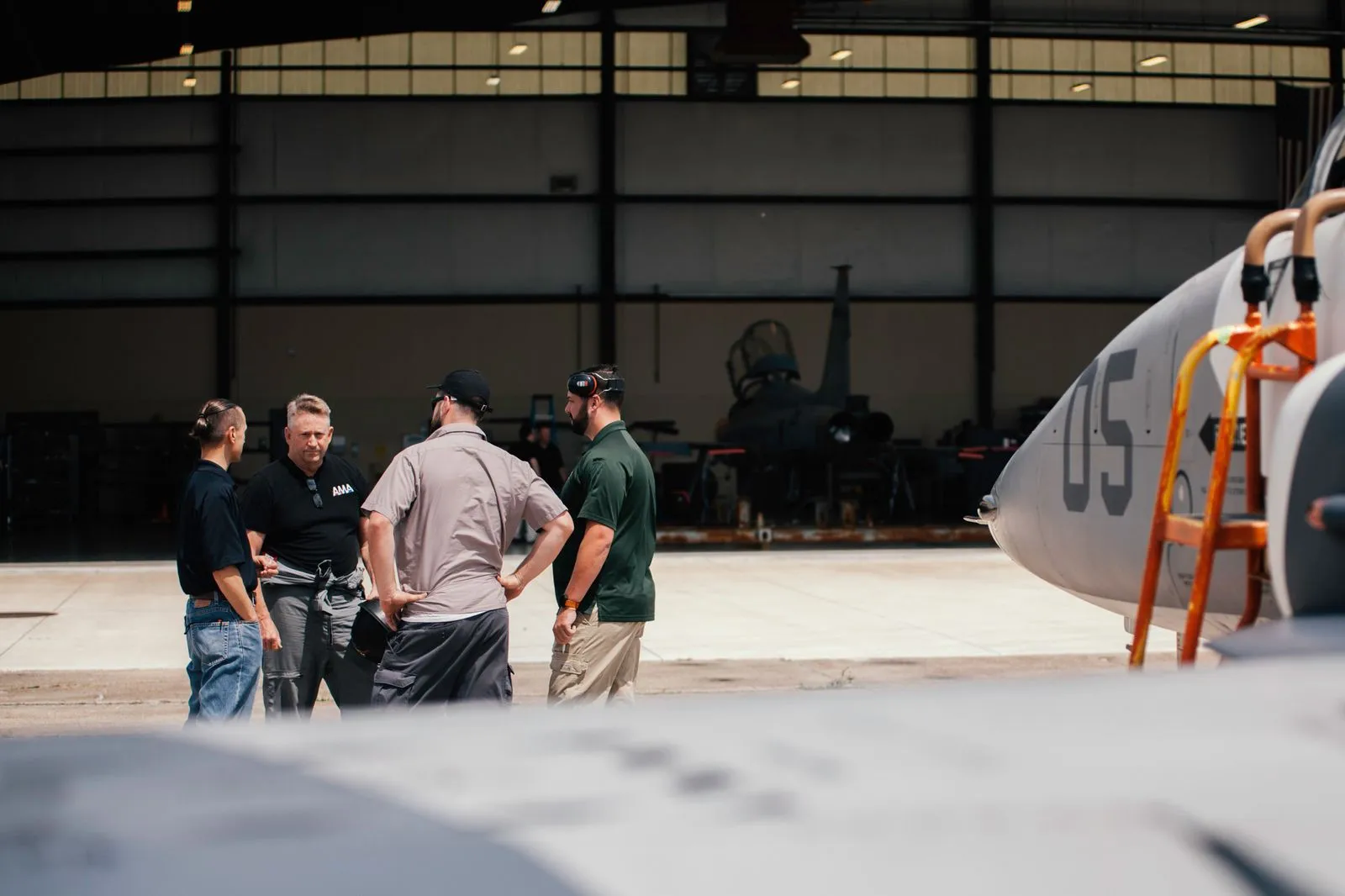 Tactical Air Support mechanics standing next to F5 fighter