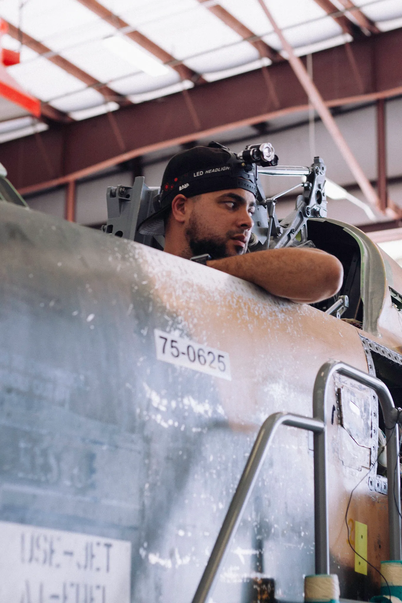 Tactical Air Support mechanic working in F5 cockpit