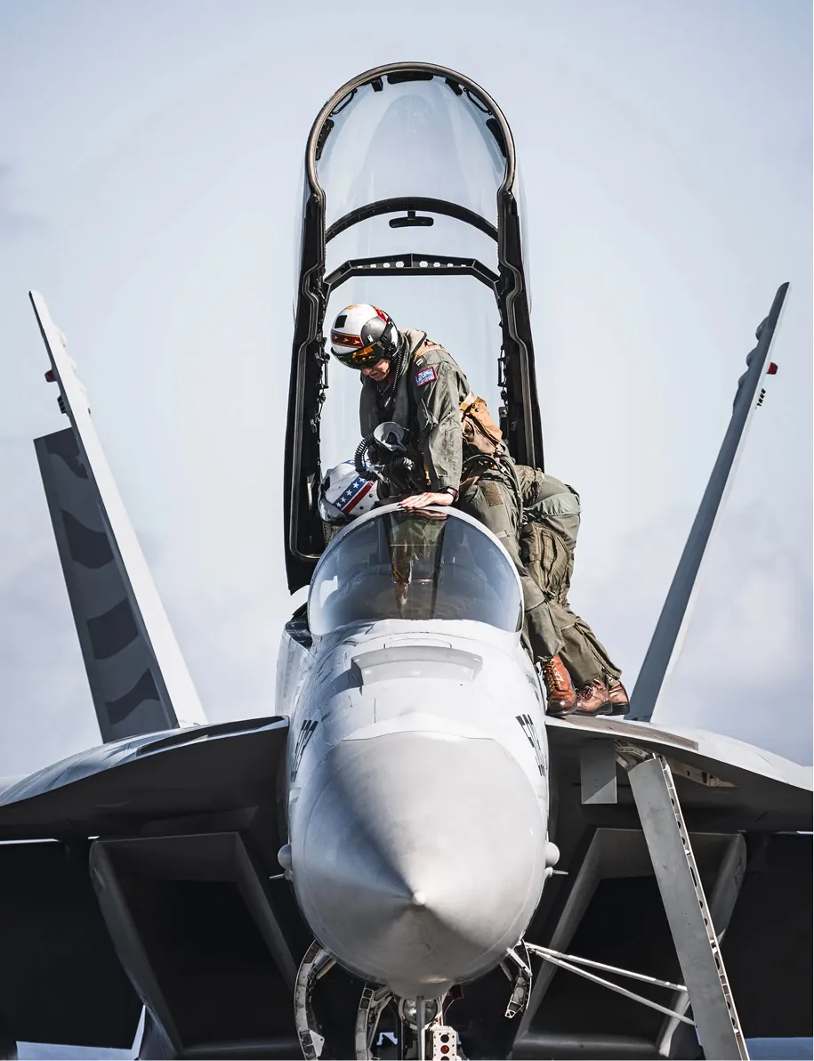 Pilots entering an open fighter cockpit