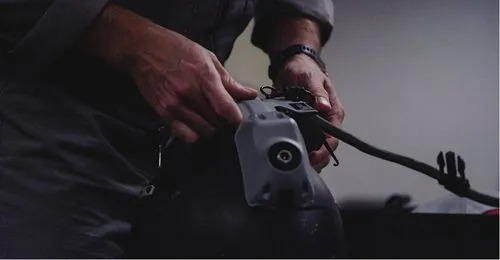 Tactical Air Support pilot hands on helmet.