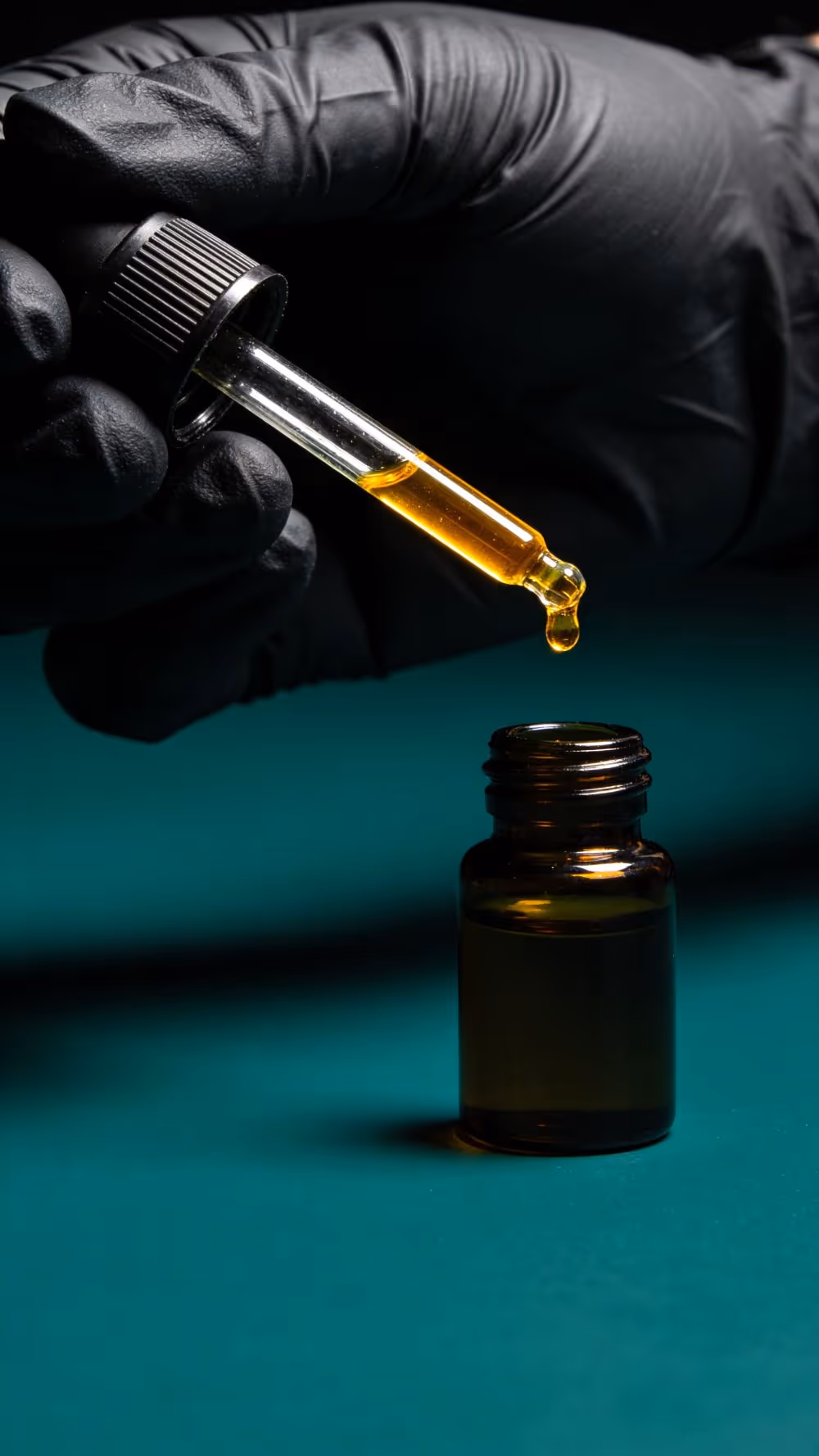 Pure fragrance oil being poured into a bottle