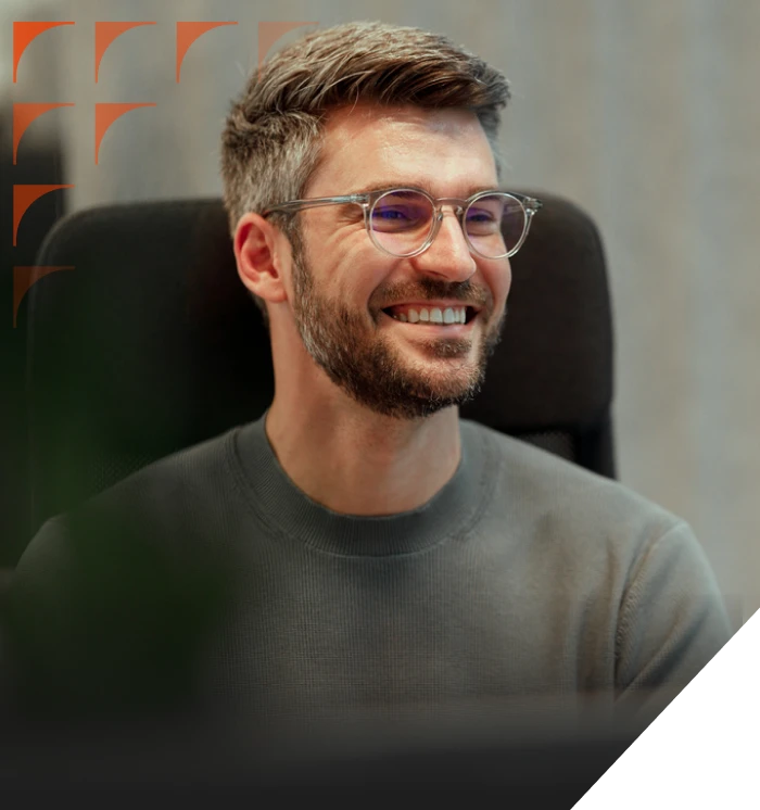 Smiling sales development specialist at a desk