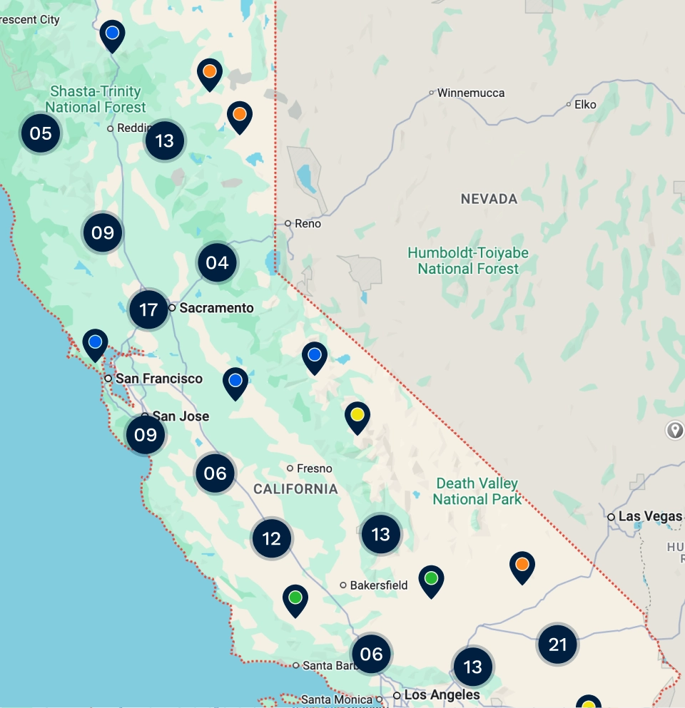 Map of California showing icons representing electric vehicle charging locations with clustered numbers in various cities and color-coded pins for operators.