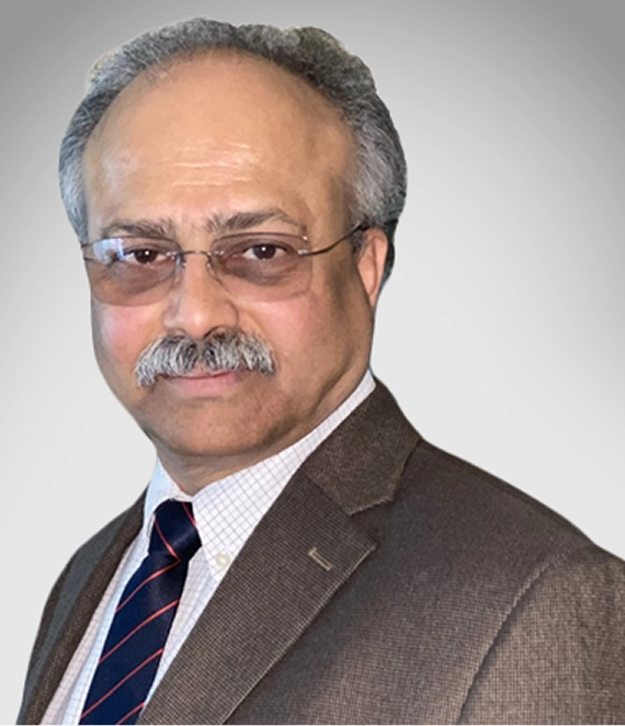 Middle-aged man with gray hair and mustache wearing glasses, a brown suit jacket, white shirt, and striped tie.