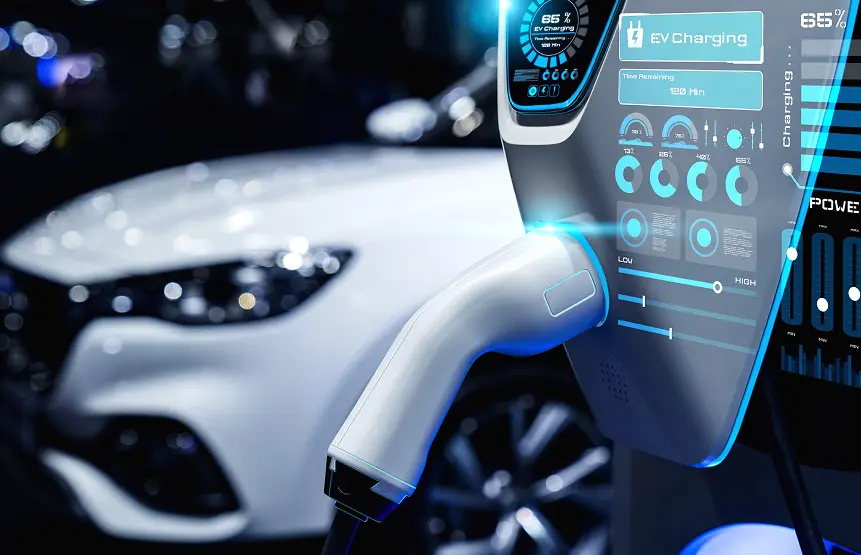 Close-up of an electric vehicle charging handle connected to a futuristic EV charging station with digital display.