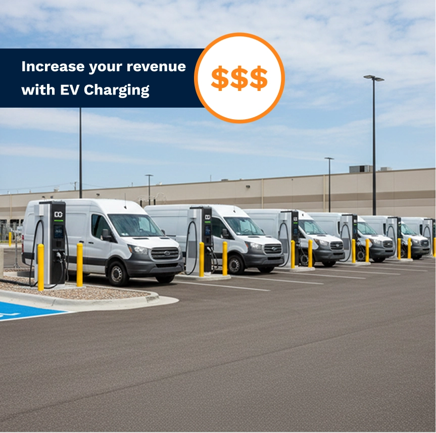Several white vans parked at EV charging stations in a large lot under a partly cloudy sky.