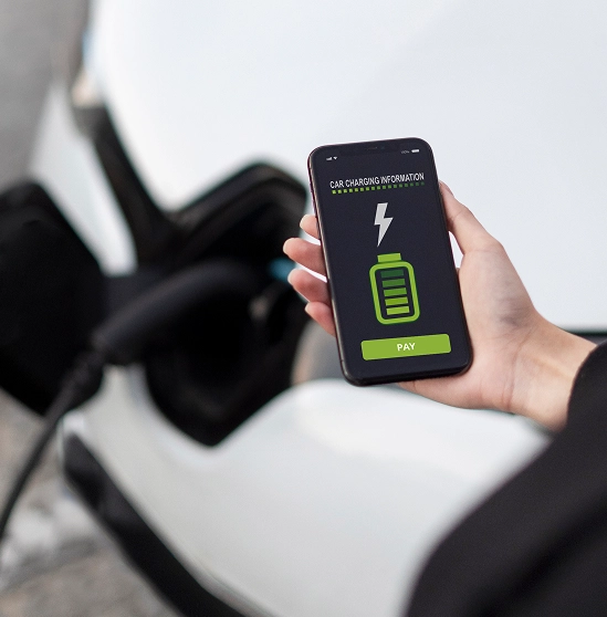 Hand holding phone displaying car charging info and a green battery icon with a pay button.