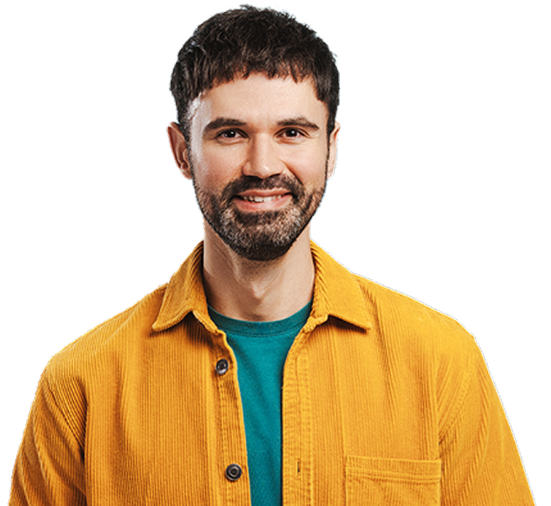 Smiling man with a beard, wearing a yellow corduroy shirt over a teal t-shirt.