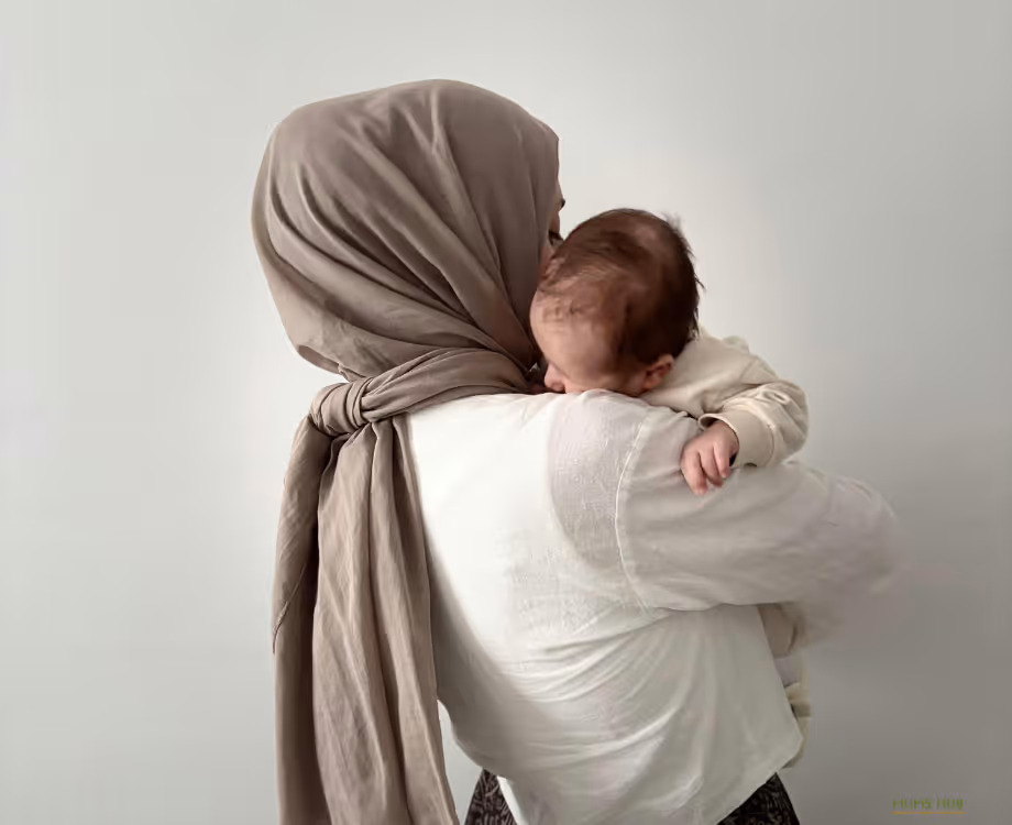 Mother holding her child at home