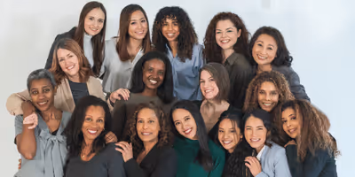 Diverse group of women smiling together in a community setting