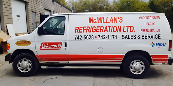 White McMillan's Refrigeration Ltd. service van with red lettering advertising air conditioning, heating, refrigeration, and sales & service.