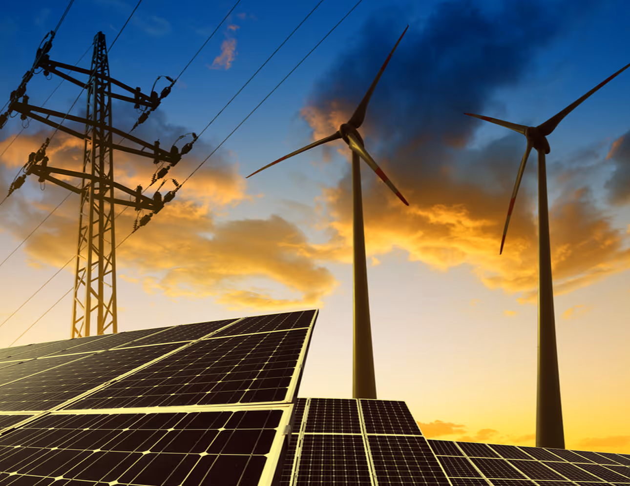 Solar panels and wind turbines with a power transmission tower at sunset under a partly cloudy sky.