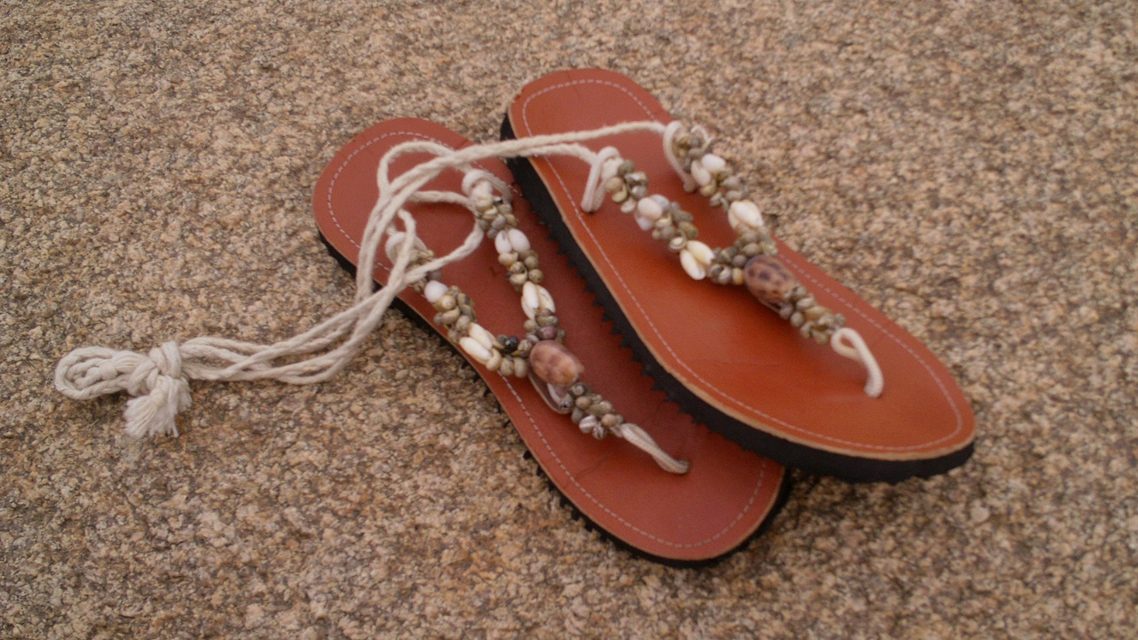 Brown thong sandals decorated with shells and beads