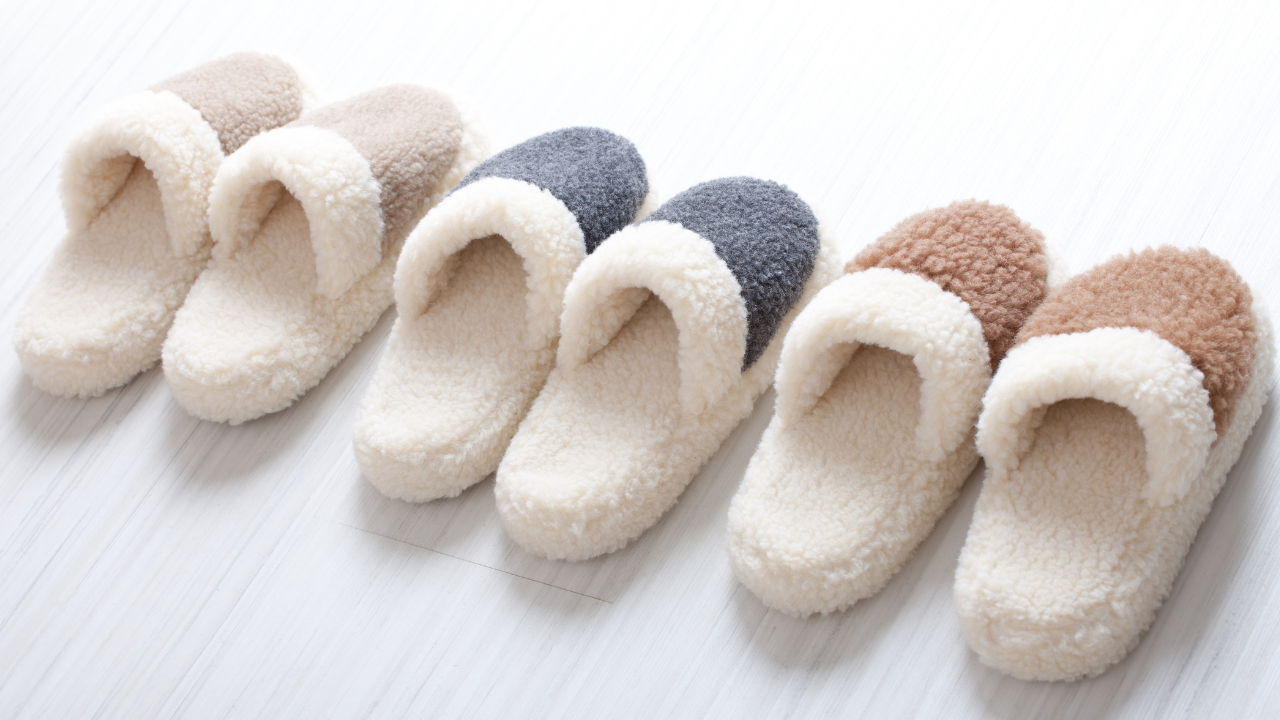 Three pairs of fleece-lined slippers in cream, gray, and brown