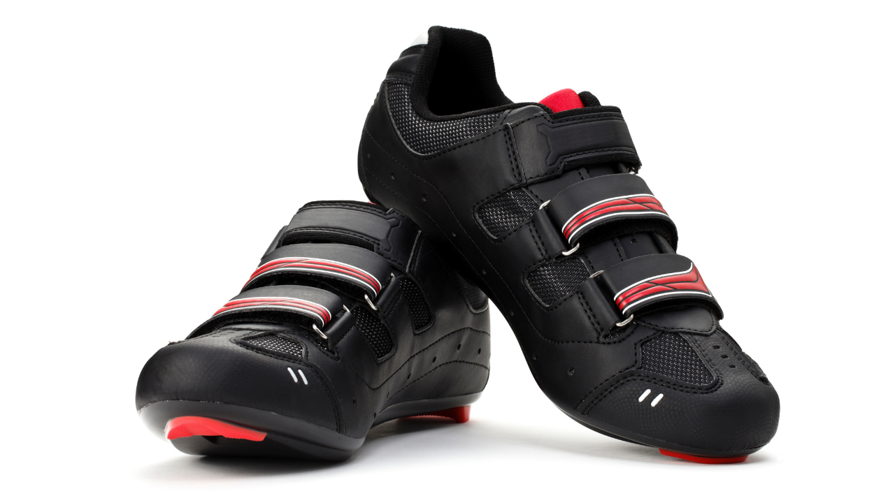 Black cycling shoes with red details and hook-and-loop straps