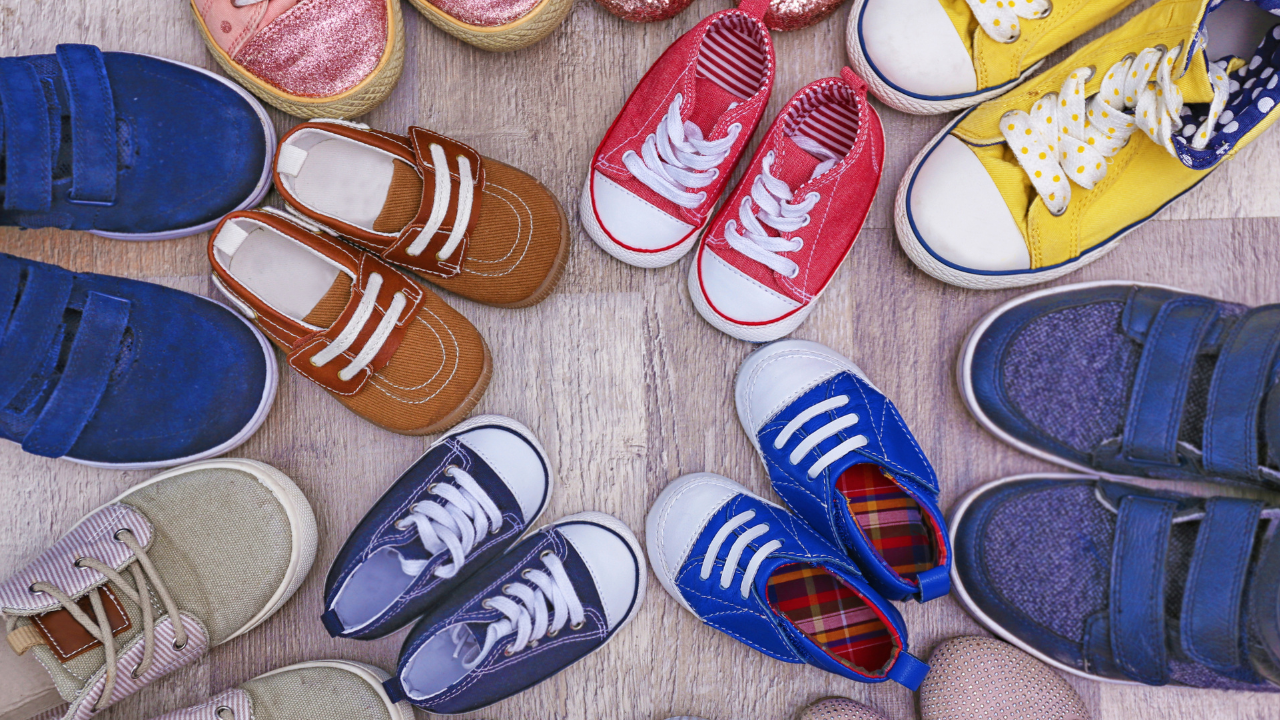 Assorted colorful children's shoes arranged in a circle