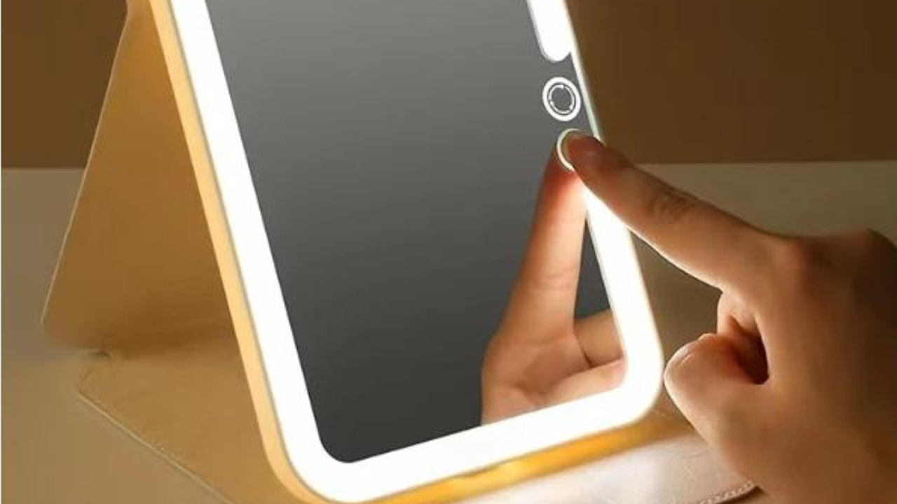 A small light-up travel mirror standing open