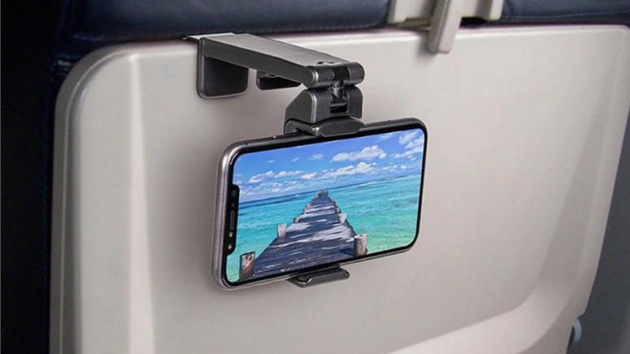A small holder supporting a phone above a travel tray