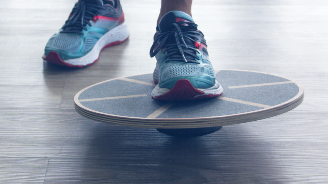 Shoes on a round wooden balance board