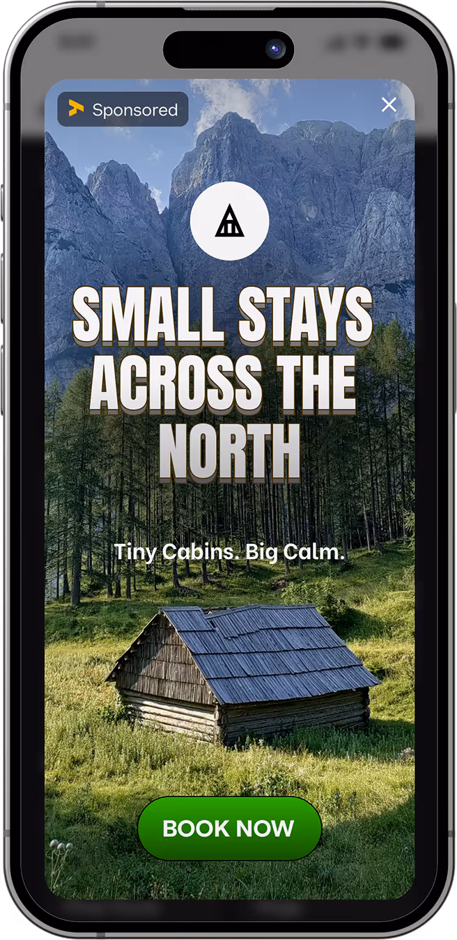 Smartphone screen showing an ad for small cabin stays in a mountainous forest area with a wooden cabin and a green 'Book Now' button.
