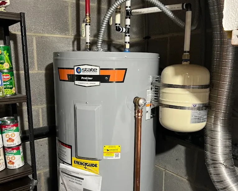 State ProLine commercial grade residential electric water heater installed next to shelving with canned goods.