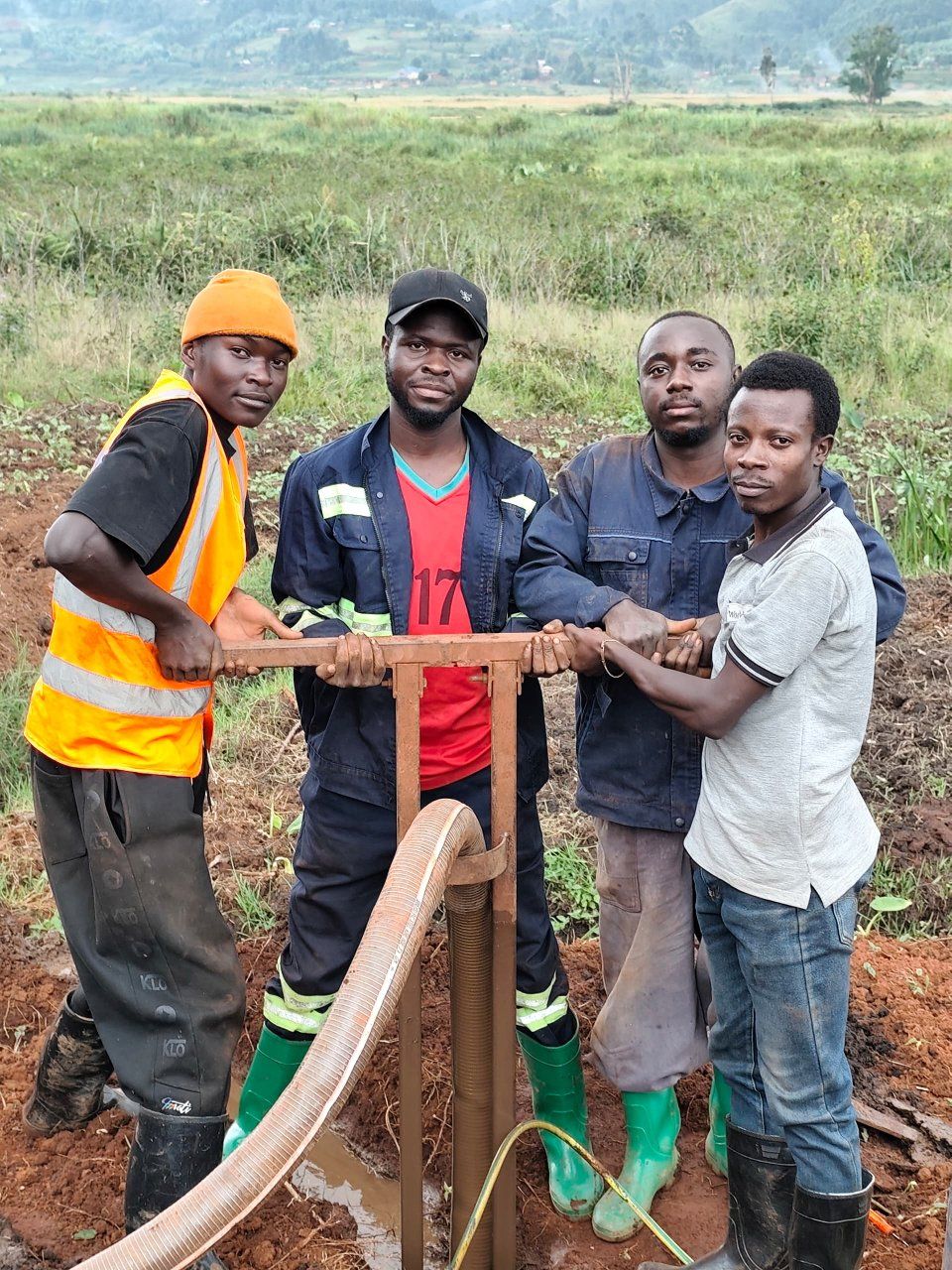 A village drilling crew working the rig by hand