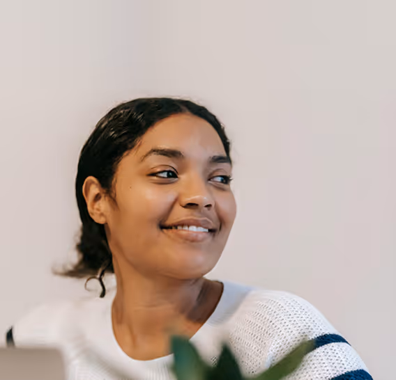 Smiling woman with dark hair in a white sweater beneath a graphic showing total cholesterol reduced from 260 to 210.