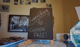 Chalkboard sign reading GLUTEN FREE — BFree safety certification article imagery